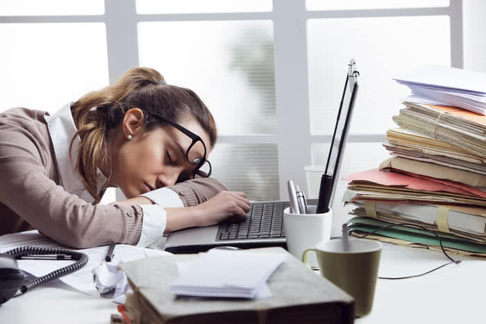 tired woman asleep on desk